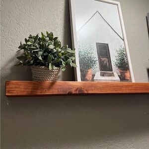Rustic Brown Wooden Wall Shelf with Greenery